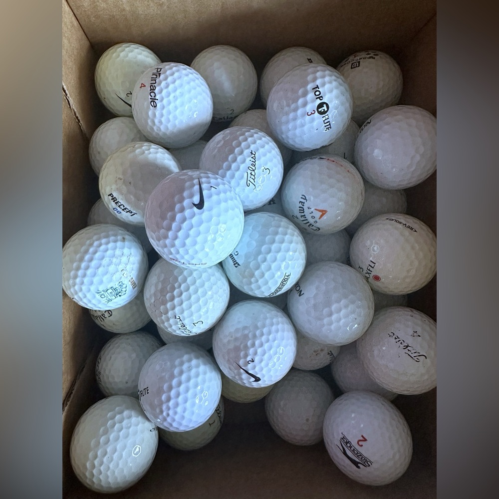 39 used golf balls, different brands.